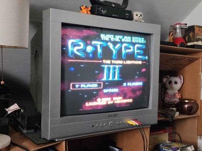 A photo of a Polaroid TTM-2004R in use, displaying R-Type III for the SNES